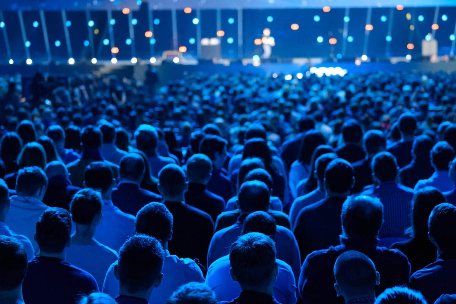 Crowd of attendees at a social event focused on a presentation, highlighting event security by Global Risk Solutions, Inc.