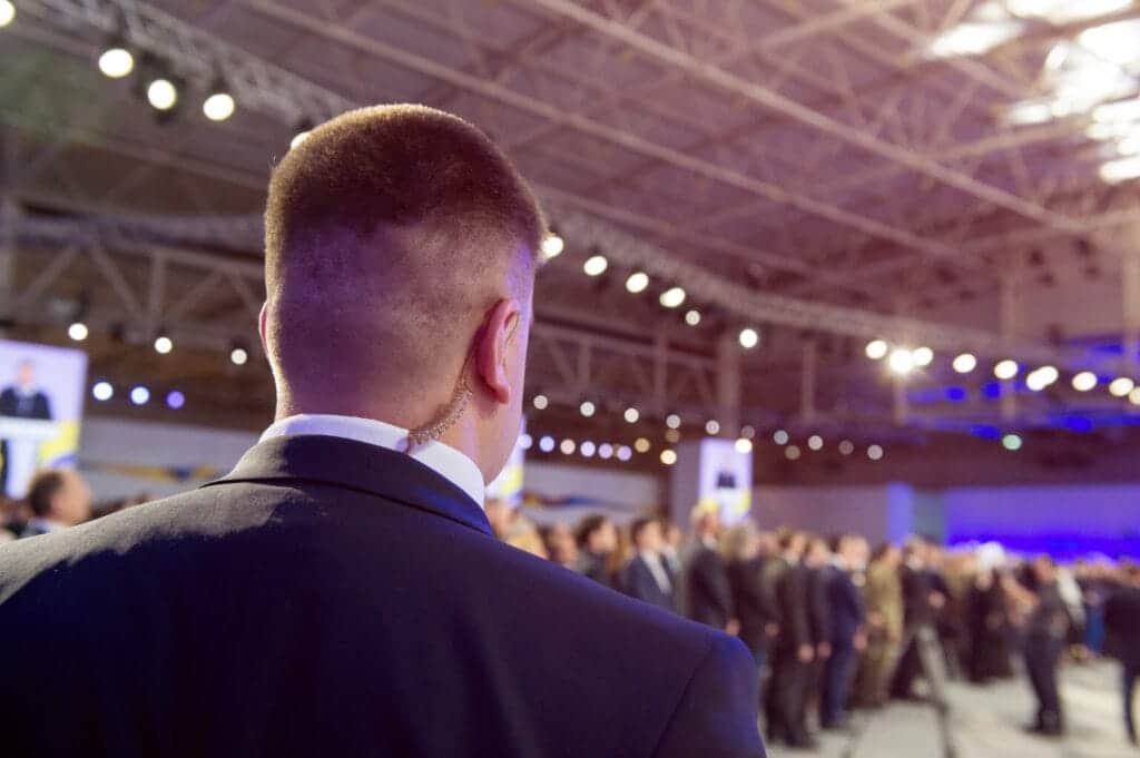 Back view of a focused security guard monitoring a corporate event, ensuring attendee safety with Global Risk Solutions, Inc.