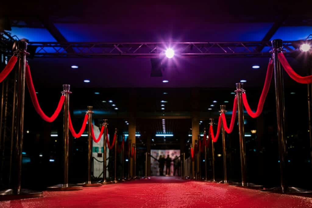 Elegant red carpet event entrance, secured by Global Risk Solutions, Inc., with velvet ropes and spotlights.