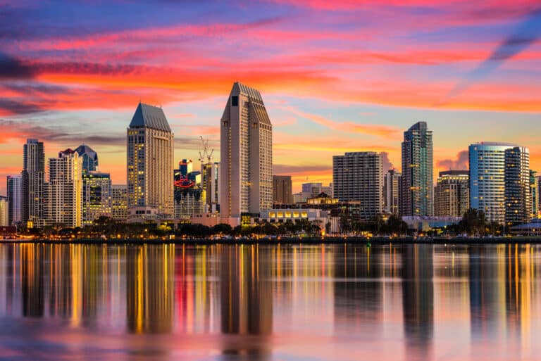 Stunning sunset over the San Diego downtown skyline, with reflections on the water at Seaport Village.