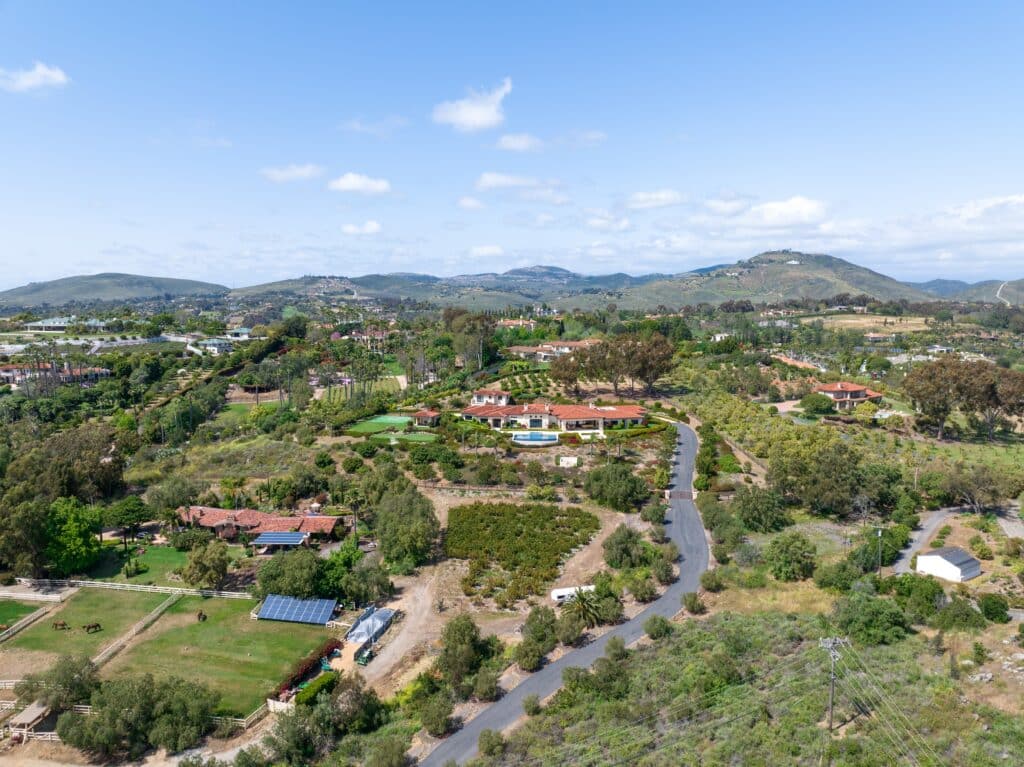 Aerial view of a serene suburban community with lush greenery and spacious properties, illustrating the types of neighborhoods secured by Global Risk Solutions.