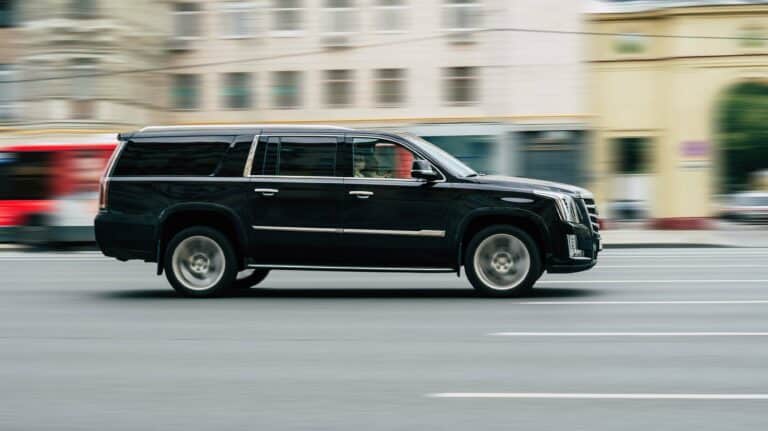 Black executive SUV in motion on a city street, provided by Global Risk Solutions for secure executive transportation in Santa Monica.