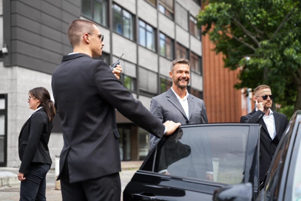 Close Protection for Celebrities provided by professional bodyguards, ensuring the safety of a high-profile businessman as he exits his car.