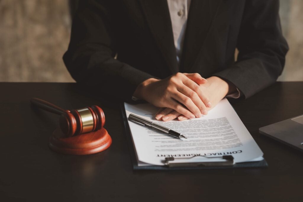 Understanding The Core Roles And Responsibilities Of A Close Protection Agent 6 A professional close protection agent reviewing a contract, symbolizing the legal and procedural expertise required in providing secure services.