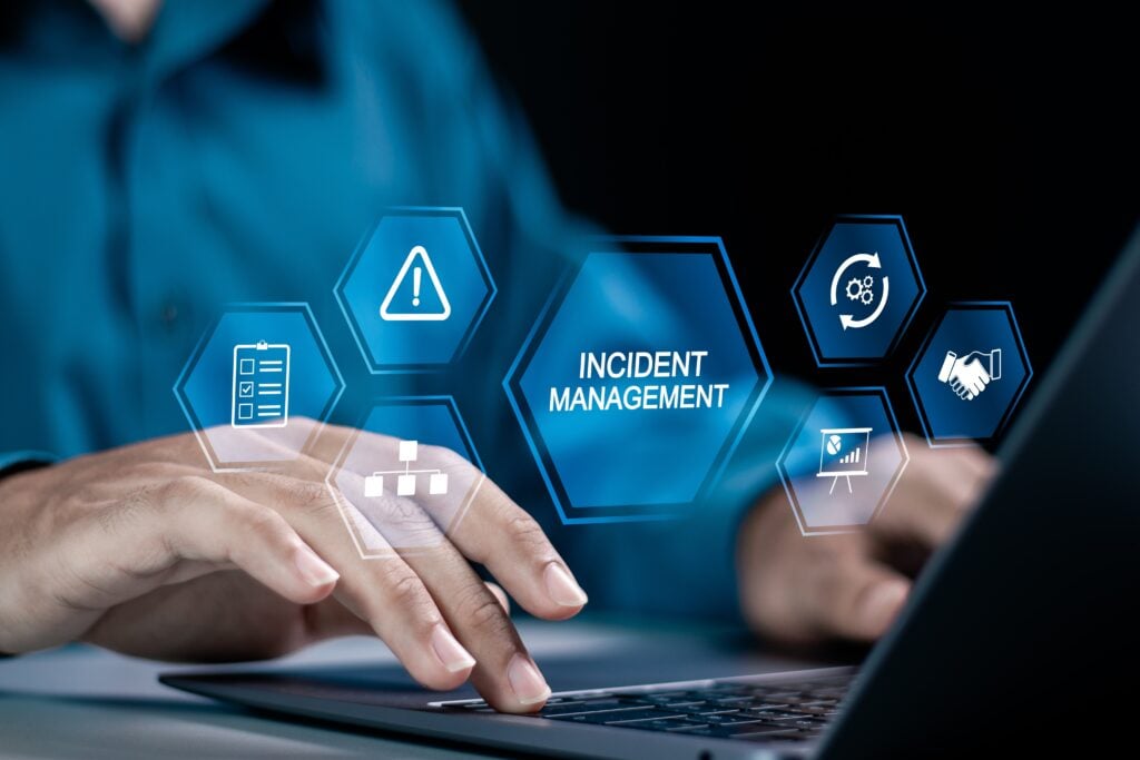 Digital illustration of "Incident Management" icons overlaying hands on a keyboard, representing the use of technology for managing business crises.
