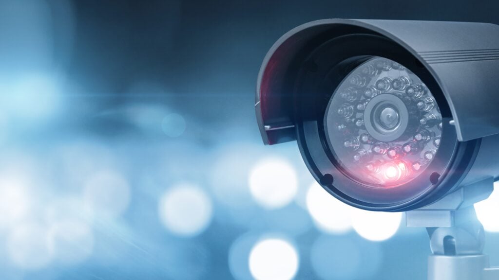 Close-up of a CCTV camera with a defocused background, representing advanced surveillance technology.