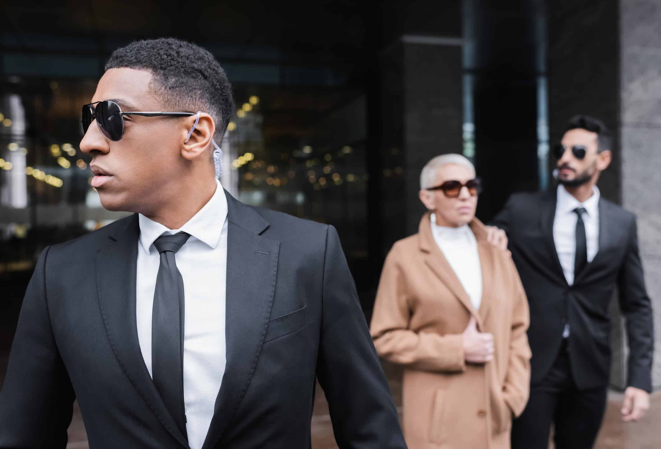 Close Protection Salary Guide team escorting client with professional detail formation near building entrance