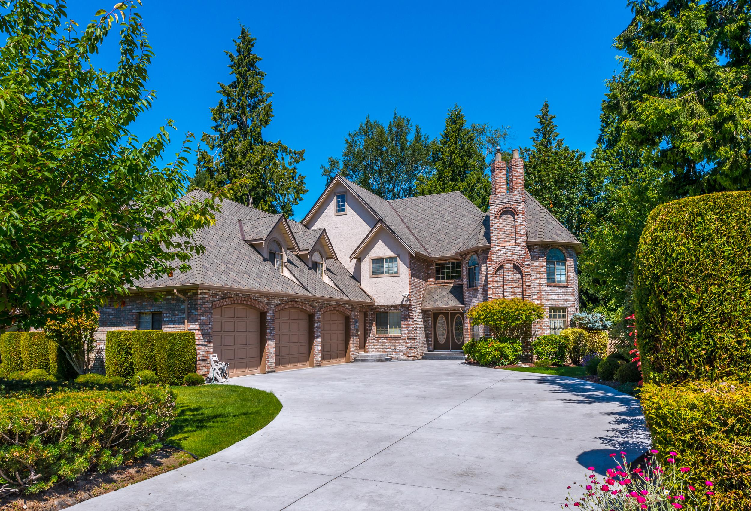 A luxury residential estate with a private driveway representing How Estate Security Services Keep Your Home Safe through proactive protection and property monitoring.